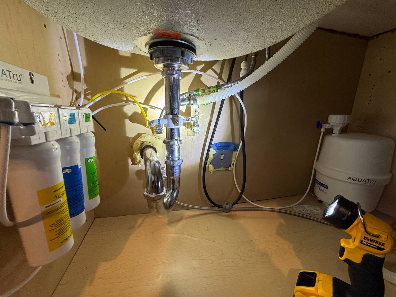 Plumbing installation under a kitchen sink